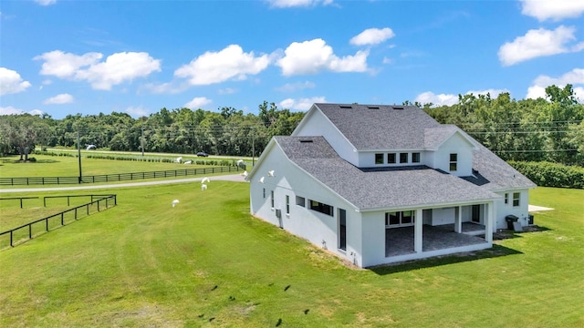1385 Ewell Rd, Lakeland, FL 33811 - rear view of house featuring stucco siding, roof with shingles, and a patio