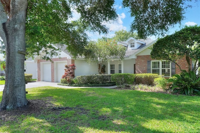 1145 Denton St, Lakeland, FL 33803 - view of front of home featuring brick siding, a front lawn, an attached garage, and concrete driveway