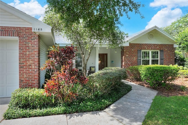 1145 Denton St, Lakeland, FL 33803 - ranch-style home with an attached garage and brick siding