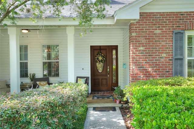 1145 Denton St, Lakeland, FL 33803 - view of exterior entry with brick siding and a porch