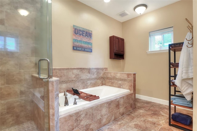 1145 Denton St, Lakeland, FL 33803 - full bath with a bath, a stall shower, and tile patterned floors
