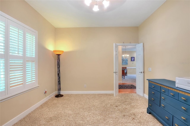 1145 Denton St, Lakeland, FL 33803 - carpeted bedroom featuring a chandelier and multiple windows