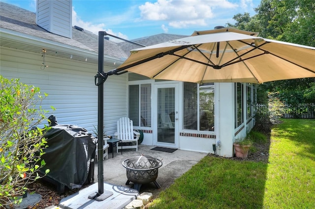 1145 Denton St, Lakeland, FL 33803 - back of property with an outdoor fire pit, a patio area, roof with shingles, a lawn, and a chimney