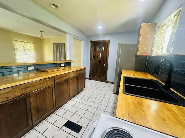 938 E Lowell St, Lakeland, FL 33805 - kitchen with wood counters, a sink, healthy amount of natural light, and recessed lighting