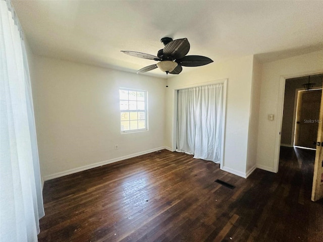 938 E Lowell St, Lakeland, FL 33805 - unfurnished bedroom featuring baseboards, dark wood-style floors, ceiling fan, and a closet