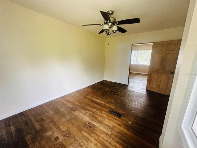 938 E Lowell St, Lakeland, FL 33805 - unfurnished room with a ceiling fan, dark wood-type flooring, and baseboards