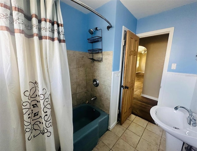 938 E Lowell St, Lakeland, FL 33805 - full bath with shower / bathtub combination with curtain, a sink, tile patterned flooring, and a wainscoted wall