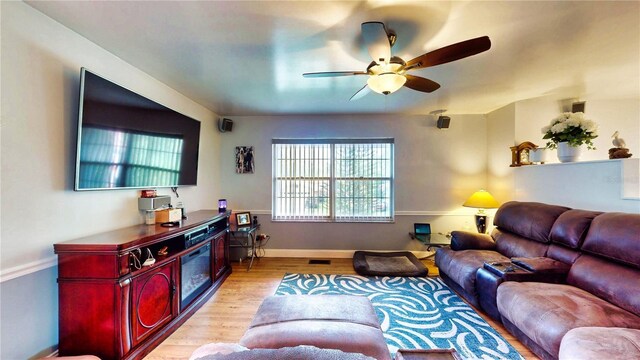 2333 Cheshire Pl, Lakeland, FL 33810 - living area featuring a ceiling fan, light wood-style flooring, and baseboards