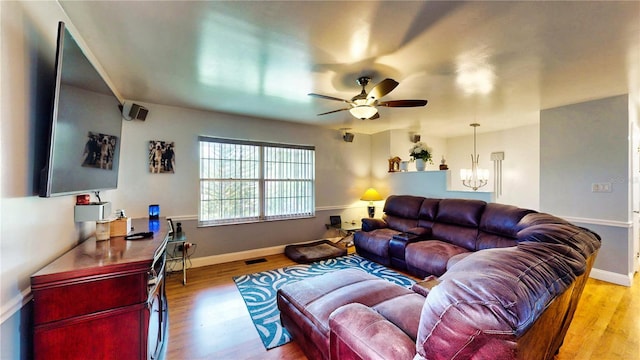 2333 Cheshire Pl, Lakeland, FL 33810 - living room featuring ceiling fan, light wood-type flooring, and a chandelier