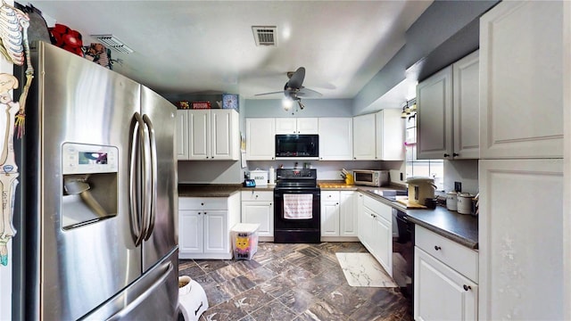 2333 Cheshire Pl, Lakeland, FL 33810 - kitchen with black appliances, ceiling fan, white cabinetry, and dark marble finish flooring