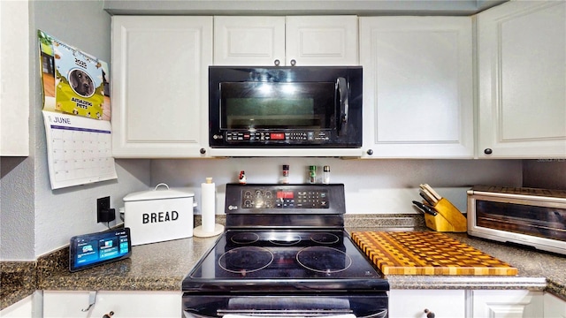 2333 Cheshire Pl, Lakeland, FL 33810 - kitchen with electric stove, black microwave, and white cabinetry