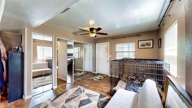 2333 Cheshire Pl, Lakeland, FL 33810 - unfurnished bedroom with two closets, wood finished floors, and a ceiling fan