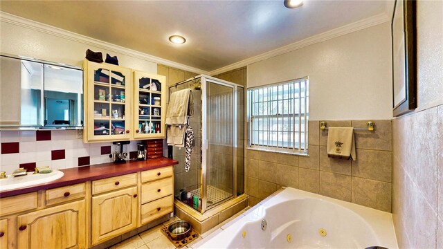 2333 Cheshire Pl, Lakeland, FL 33810 - full bath featuring a stall shower, vanity, crown molding, a jetted tub, and tile walls
