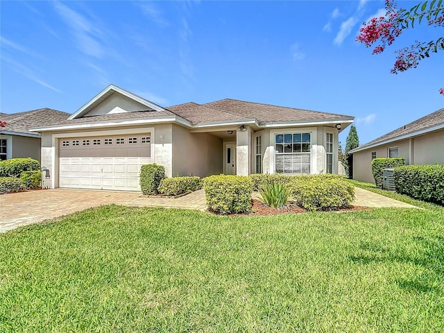 3806 Osprey Pointe Cir, Winter Haven, FL 33884 - single story home featuring stucco siding, a front yard, a garage, and driveway