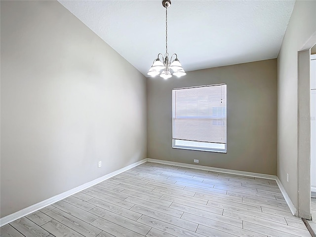 3806 Osprey Pointe Cir, Winter Haven, FL 33884 - unfurnished room featuring a chandelier and light wood-type flooring