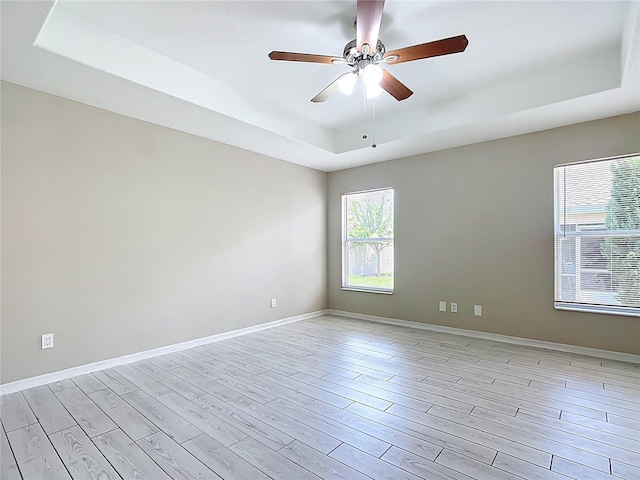 3806 Osprey Pointe Cir, Winter Haven, FL 33884 - unfurnished room with a raised ceiling, light wood-style floors, and ceiling fan