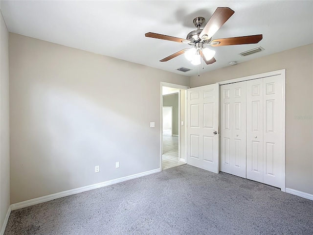 3806 Osprey Pointe Cir, Winter Haven, FL 33884 - unfurnished bedroom with carpet floors, a closet, and a ceiling fan
