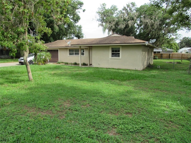 1440 Hackl Blvd, Bartow, FL 33830 - rear view of house featuring stucco siding and an attached garage