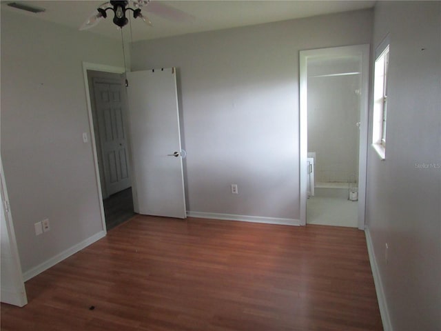 1440 Hackl Blvd, Bartow, FL 33830 - unfurnished bedroom with wood finished floors, baseboards, and ensuite bathroom