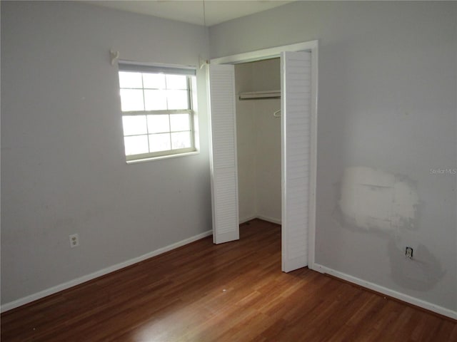 1440 Hackl Blvd, Bartow, FL 33830 - unfurnished bedroom with wood finished floors, baseboards, and a closet