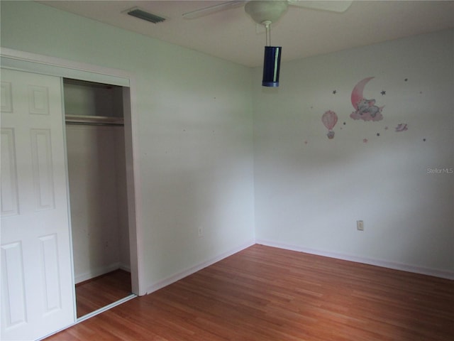 1440 Hackl Blvd, Bartow, FL 33830 - unfurnished bedroom featuring wood finished floors, a closet, baseboards, and a ceiling fan