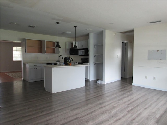 1440 Hackl Blvd, Bartow, FL 33830 - kitchen featuring open shelves, electric range, light countertops, and baseboards