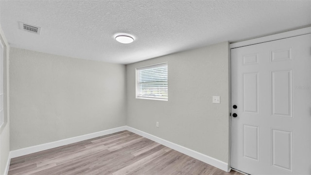 980 S Mill Ave, Bartow, FL 33830 - spare room featuring a textured ceiling and light wood finished floors