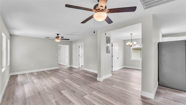 980 S Mill Ave, Bartow, FL 33830 - empty room with a ceiling fan, a chandelier, and light wood finished floors