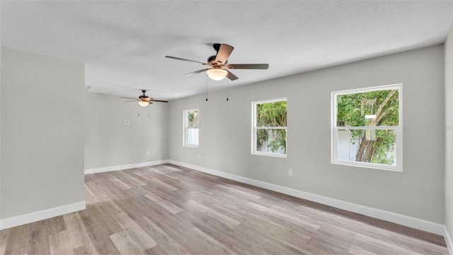 980 S Mill Ave, Bartow, FL 33830 - empty room featuring light wood-style flooring, ceiling fan, and a textured ceiling