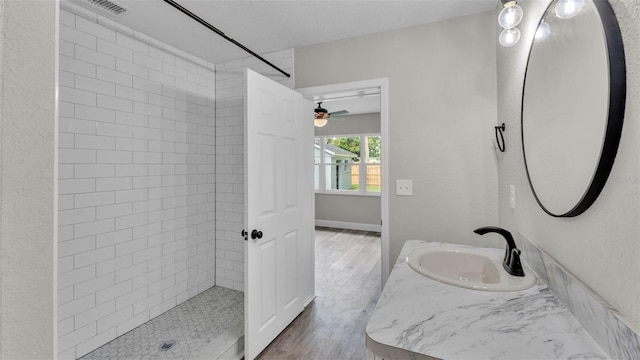 980 S Mill Ave, Bartow, FL 33830 - bathroom featuring wood finished floors, vanity, ceiling fan, and tiled shower
