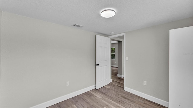 980 S Mill Ave, Bartow, FL 33830 - unfurnished room with wood finished floors and a textured ceiling