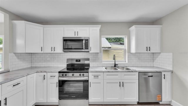980 S Mill Ave, Bartow, FL 33830 - kitchen with stainless steel appliances, plenty of natural light, and white cabinetry