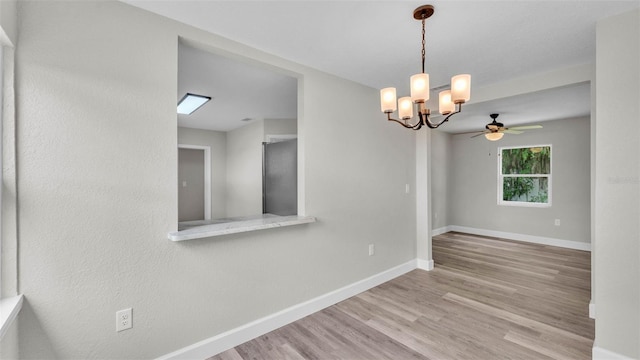 980 S Mill Ave, Bartow, FL 33830 - empty room featuring wood finished floors, a ceiling fan, and a chandelier