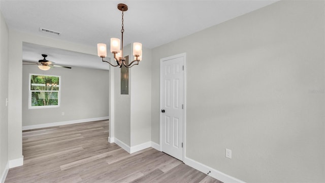 980 S Mill Ave, Bartow, FL 33830 - spare room with light wood-style floors, a chandelier, and ceiling fan