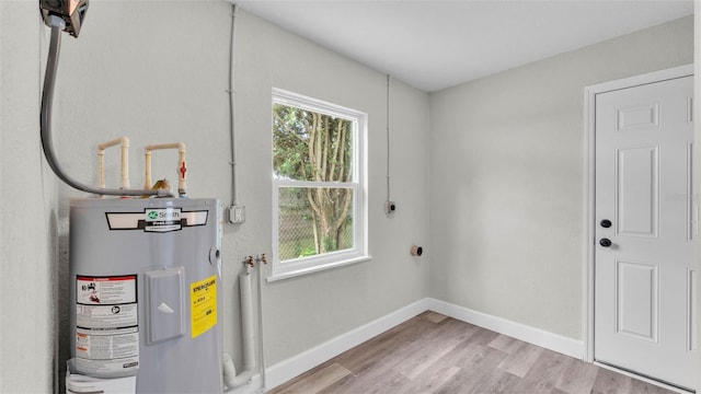 980 S Mill Ave, Bartow, FL 33830 - laundry room featuring electric water heater and wood finished floors