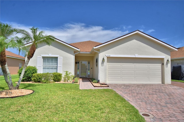 4188 Muirfield Loop, Lake Wales, FL 33859 - ranch-style house with stucco siding, an attached garage, decorative driveway, and a front yard
