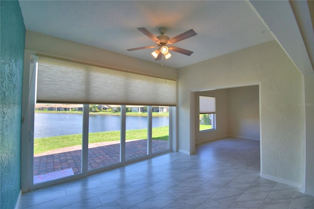 4188 Muirfield Loop, Lake Wales, FL 33859 - spare room featuring a water view, ceiling fan, and a textured wall