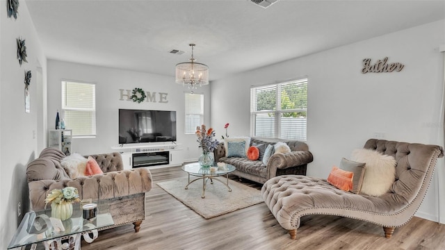 1125 Mattie Pointe Blvd, Auburndale, FL 33823 - living room with wood finished floors and a chandelier