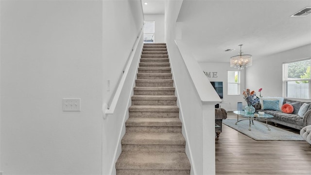 1125 Mattie Pointe Blvd, Auburndale, FL 33823 - stairs with wood finished floors and a chandelier