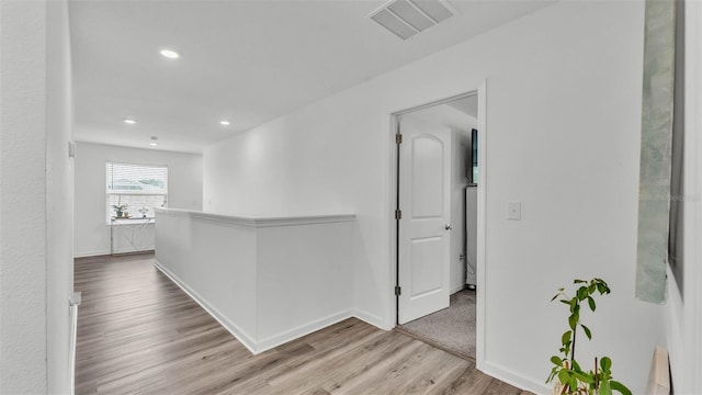 1125 Mattie Pointe Blvd, Auburndale, FL 33823 - corridor with wood finished floors, an upstairs landing, and recessed lighting
