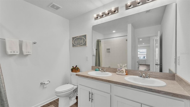 1125 Mattie Pointe Blvd, Auburndale, FL 33823 - bathroom with double vanity, wood finished floors, and a shower with shower curtain