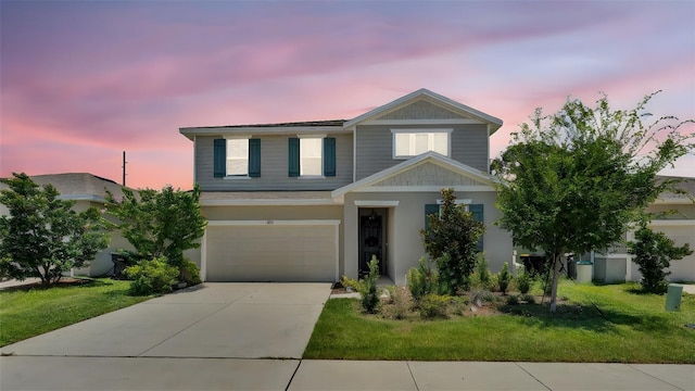 1125 Mattie Pointe Blvd, Auburndale, FL 33823 - traditional home featuring an attached garage, driveway, a front lawn, and stucco siding