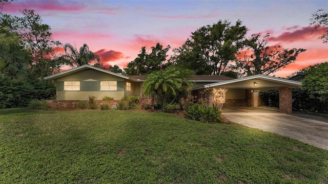 4219 Forest Hills Dr, Lakeland, FL 33813 - ranch-style home with concrete driveway, a lawn, and an attached carport