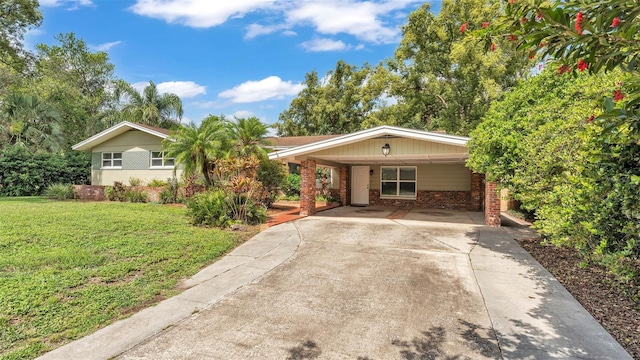 4219 Forest Hills Dr, Lakeland, FL 33813 - view of front of property featuring a front yard, brick siding, driveway, and an attached carport