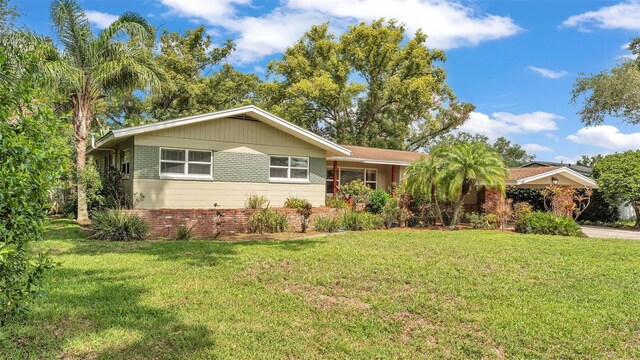 4219 Forest Hills Dr, Lakeland, FL 33813 - ranch-style house with a front yard