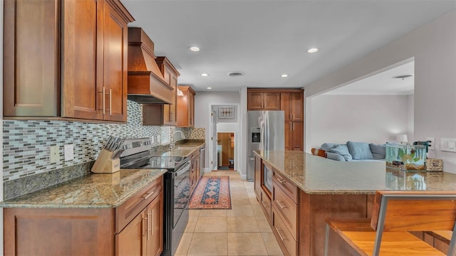 4219 Forest Hills Dr, Lakeland, FL 33813 - kitchen featuring appliances with stainless steel finishes, premium range hood, decorative backsplash, brown cabinets, and recessed lighting