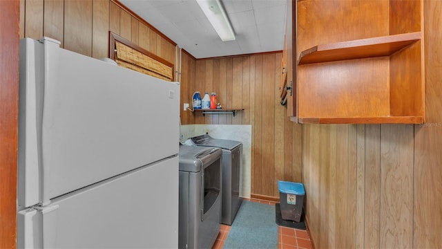 4219 Forest Hills Dr, Lakeland, FL 33813 - laundry room featuring wood walls and independent washer and dryer