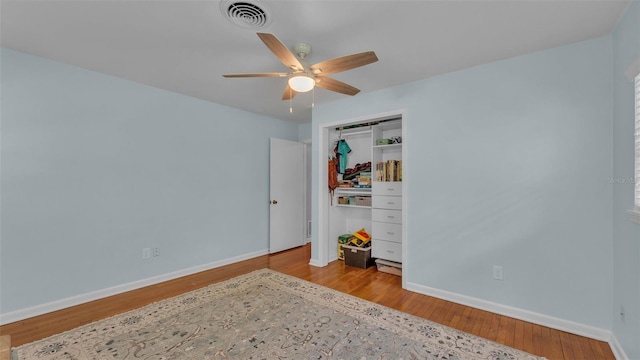 4219 Forest Hills Dr, Lakeland, FL 33813 - bedroom with wood finished floors, a closet, and ceiling fan
