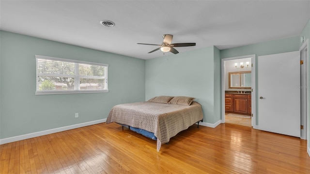4219 Forest Hills Dr, Lakeland, FL 33813 - bedroom with light wood finished floors, a ceiling fan, and ensuite bath