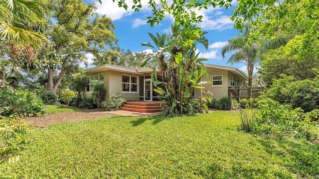 4219 Forest Hills Dr, Lakeland, FL 33813 - rear view of property with a wooden deck, concrete block siding, and a sunroom